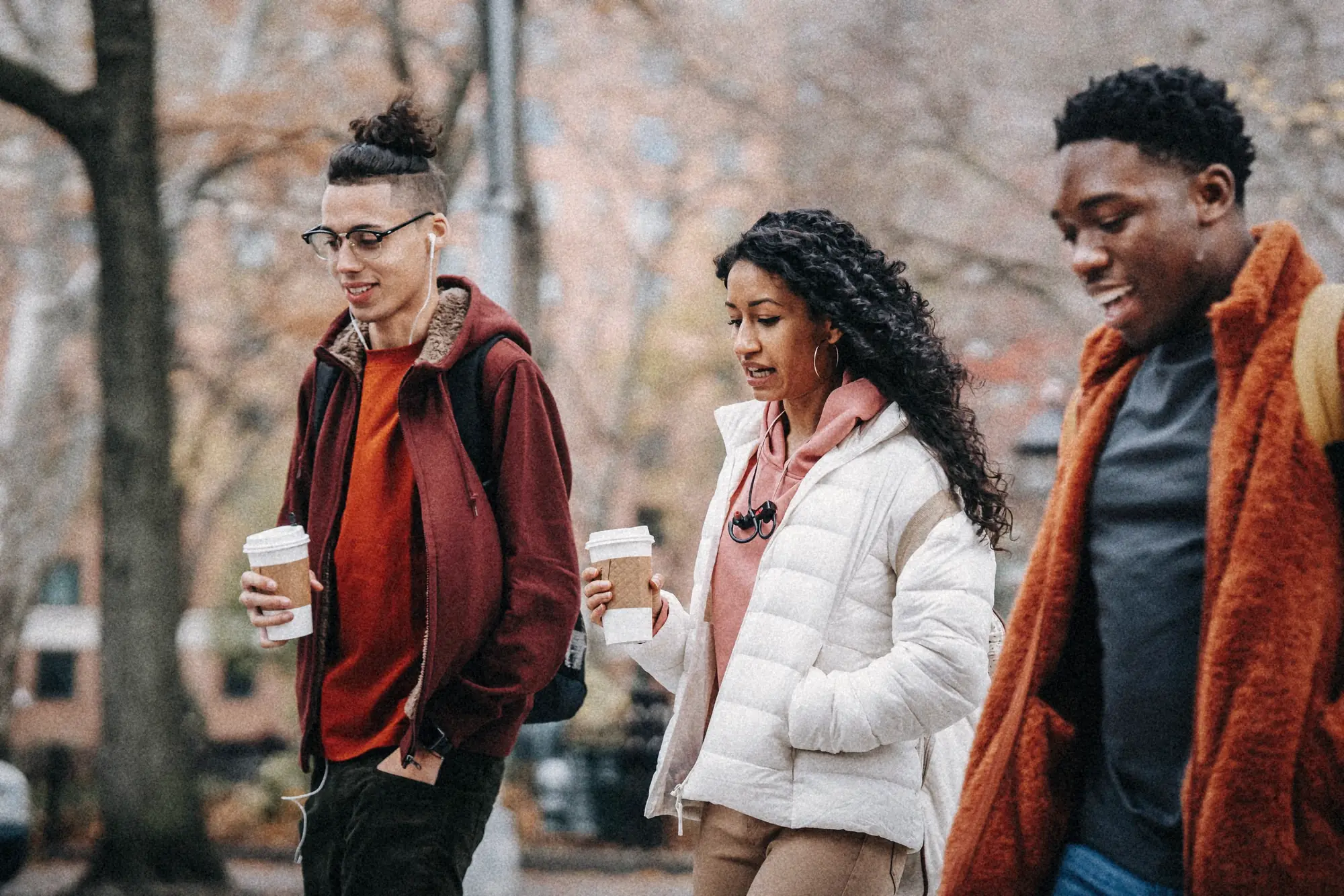 Three friends walking and laughing together